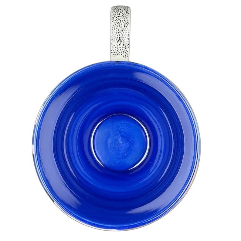 Cassie Byrnes Anthropologie Mug in deep blue with a glossy spiral design and textured handle