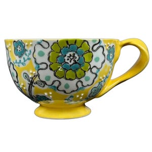 Anthropologie Elka Ayaka floral pedestal mug bright yellow ceramic with turquoise and green floral pattern and handle