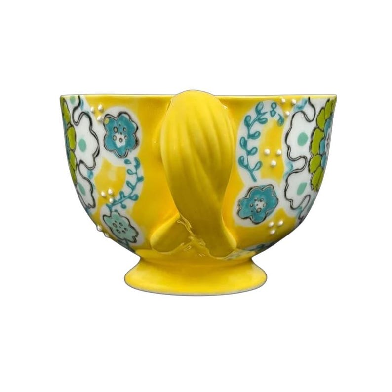 Anthropologie Elka Ayaka floral pedestal mug in glossy yellow with turquoise and green hand painted flowers