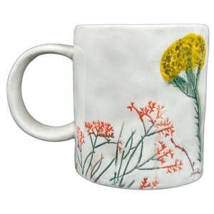 Anthropologie Dagny T monogram initial mug with colorful floral design and sturdy handle