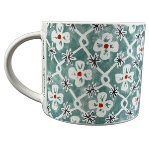 Anthropologie Alexandre Dumas G monogram initial mug turquoise ceramic coffee cup with white floral lattice and red centers