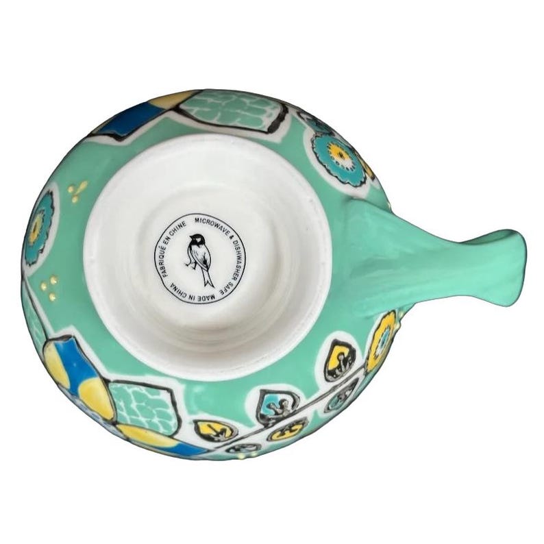 Top view of Anthropologie Elka Ayaka green floral pedestal mug showing mint green floral pattern and interior maker stamp