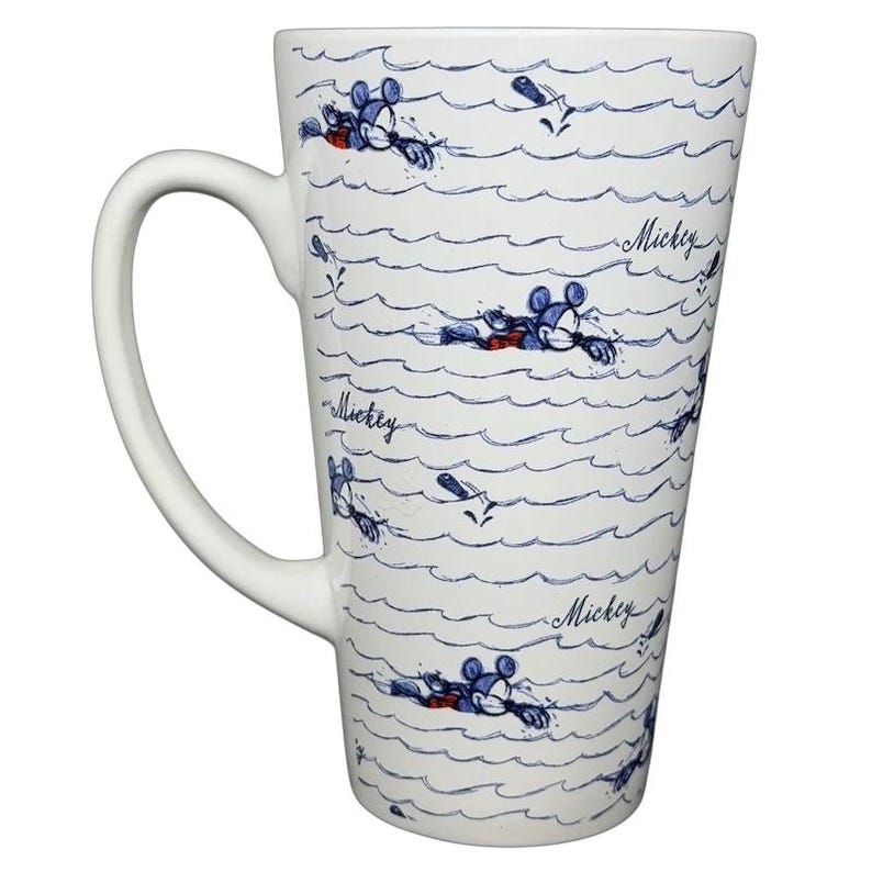 Mickey Mouse Swimming Mug Disney featuring Mickey in a boat on wavy water pattern