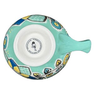 Top view of Anthropologie Elka Ayaka green floral pedestal mug showing turquoise handle and yellow blue floral pattern