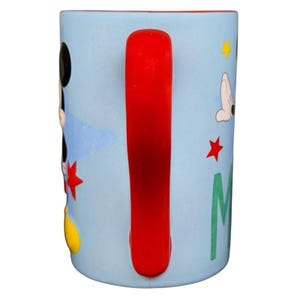 Mickey Mouse embossed stars Disney mug featuring a colorful design with a red handle