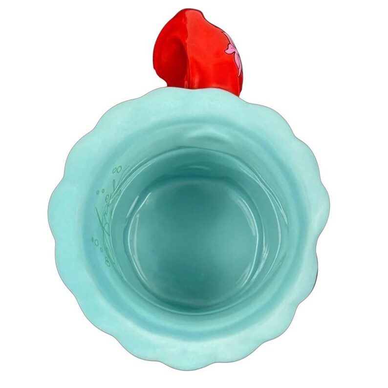 Top view of ceramic turquoise scalloped mug with red Ariel handle Ariel The Little Mermaid Disney Parks vintage mug