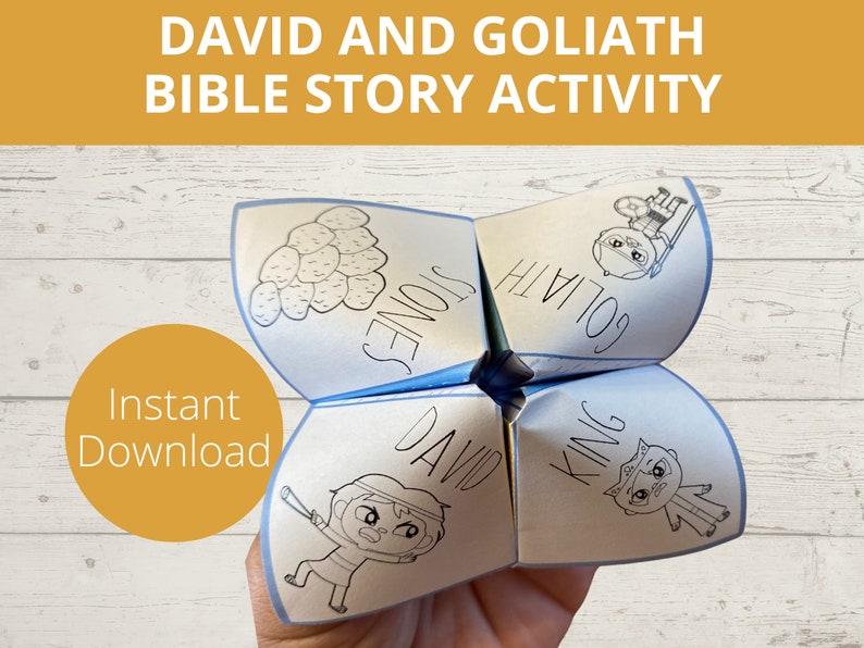 May include: A blue and white paper game with the words "David", "Goliath", "King", and "Stones" on it. The game is folded into a cube shape and is being held by a hand. The text "Instant Download" is visible in the lower left corner of the image.