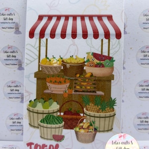 May include: A rectangular card featuring a red and white striped market stall illustration with baskets of various fruits including bananas, watermelons, and pineapples. The text SAVINGS is printed in red at the top and TOTAL = at the bottom.