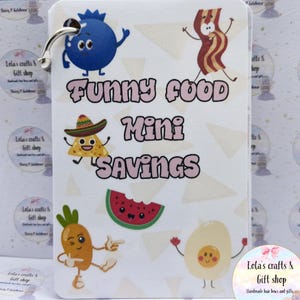 May include: A white mini savings card with a silver ring, featuring cartoon food characters including a blueberry, bacon, taco, watermelon, carrot, and egg. The text "FUNNY FOOD Mini SAVINGS" is in pink.