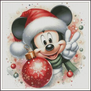 May include: Mickey Mouse wearing a red and white Santa hat, holding a red Christmas ornament with white snowflakes. He is giving a peace sign with his right hand.