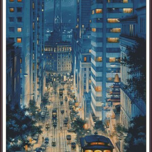 May include: A nighttime view of a city street with a cable car in the foreground. The street is lined with tall buildings and there are cars and people walking on the sidewalk. The cable car is red and yellow and has a sign that says "Cable Car" on the side.