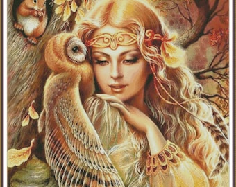 May include: A woman with long blonde hair and a golden crown sits in a forest setting. She is wearing a white dress with gold trim. A brown and white owl sits on her shoulder. The background is a blurred image of trees and leaves.