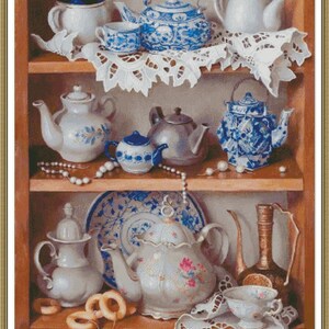 May include: A collection of teapots and cups on a wooden shelf with white lace doilies. The teapots are in various styles and colors, including blue and white porcelain, silver, and white with floral designs. There are also some pearl necklaces and a plate on the shelf.