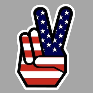 May include: A peace sign with the American flag design. The two fingers are blue with white stars and the palm is red and white stripes.