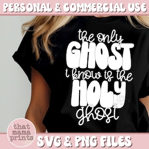 May include: A black t-shirt with white text that reads "the only GHOST i know is the HOLY ghost". The text is in a retro, bubble-letter font. The t-shirt is being worn by a person. The image also includes a small pink circle with the text "that mama prints" in white.