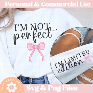 May include: White sweatshirt with the text "I'm not perfect I'm limited edition" and a pink bow. The text is in black and the bow is pink.