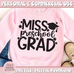 May include: Pink sweatshirt with black text that says "Miss Preschool Grad" with a graduation cap and stars.  The text is in a fun, playful font.