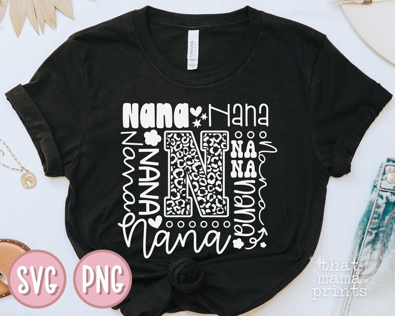 May include: Black t-shirt with a white design that says "Nana" multiple times in different fonts and sizes. The design also includes a large letter "N" with a leopard print pattern.