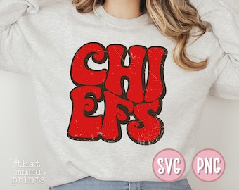 May include: A gray sweatshirt with the word "CHIEFS" in red and black retro lettering. The sweatshirt has the words "SVG" and "PNG" in pink circles on the bottom right corner.