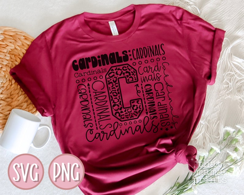 Pu&ograve; includere: Una maglietta color granata con un design grafico nero che presenta la parola "Cardinals" ripetuta in varie dimensioni e stili. Il grafico include anche una grande lettera "C" con uno stampa leopardato.