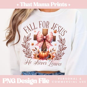 May include: White sweatshirt with a fall-themed design featuring a cross with a pink and white bow, a pumpkin, and leaves. The text "Fall for Jesus He Never Leaves" is printed on the sweatshirt.
