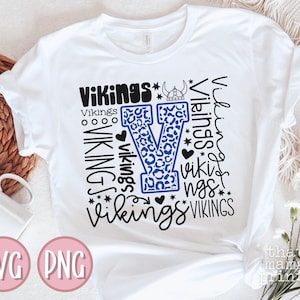 May include: White t-shirt with a blue and black leopard print "V" and the word "Vikings" repeated in different sizes and styles.