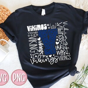 May include: Black t-shirt with a white graphic design of the letter "V" surrounded by the word "Vikings" in various sizes and styles. The "V" is blue and has a leopard print pattern.
