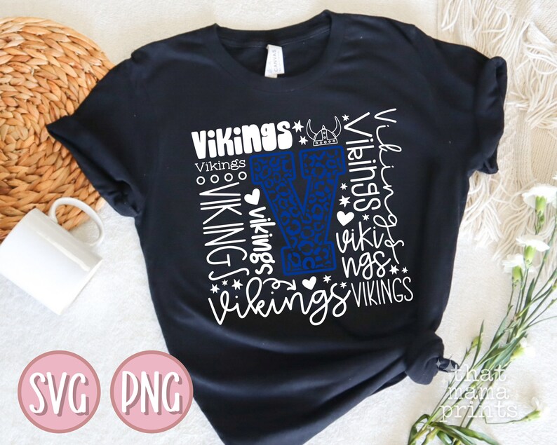 May include: Black t-shirt with a white graphic design of the letter "V" surrounded by the word "Vikings" in various sizes and styles. The "V" is blue and has a leopard print pattern.