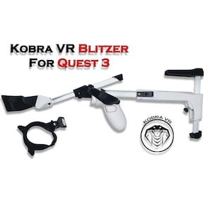 May include: A white and black VR accessory labelled "KOBRA VR BLITZER FOR QUEST 3". The accessory has a gun-like design with a handle, a trigger, and a front attachment. A black circular piece and a logo are also present.