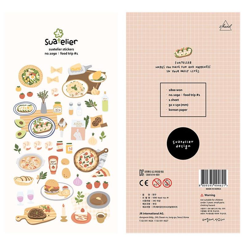 May include: A sheet of Suatelier stickers featuring food illustrations. The stickers include images of pizza, pasta, burgers, steak, and desserts. The text "Suatelier" and "food trip #1" are visible. The sheet measures 92 x 150 mm.