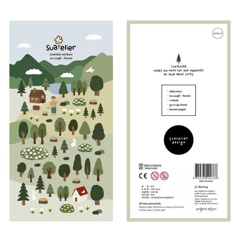 May include: A set of Suatelier forest-themed stickers. The stickers feature illustrations of trees, houses, and animals in a forest setting. The packaging includes the text "Suatelier stickers no.1098: forest" and measures 92 x 150 mm.