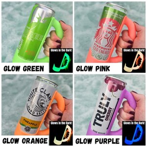 May include: Four beverage can holders in green, pink, orange, and purple. Each holder has a handle and glows in the dark. The cans include Red Bull, Starbucks Iced Energy, White Claw, and Truly Cherry.