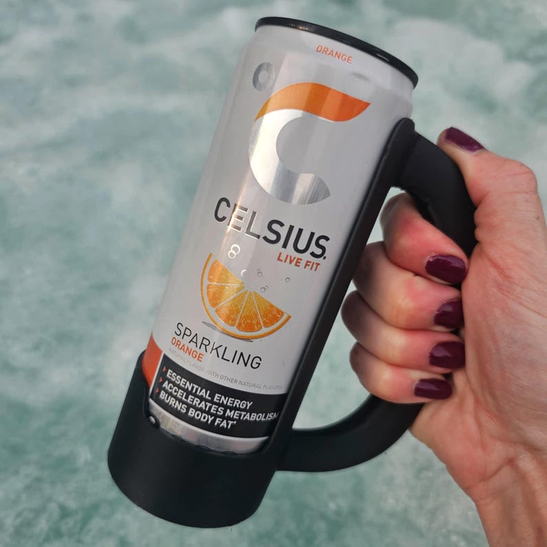 May include: A silver Celsius energy drink can with orange accents and the words "Celsius Live Fit Sparkling Orange." The can is held in a black handle. The can features a graphic of an orange slice.