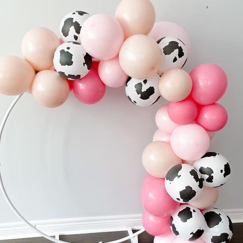 pink and cow print balloon arch