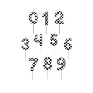 May include: Set of ten black and white chequered number candles. The candles are numbered 0 through 9.