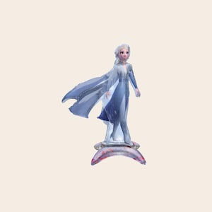May include: An inflatable foil balloon shaped like a character with long blonde hair, wearing a light blue dress with a flowing cape. The figure stands on a crescent-shaped base that is light purple with small pink and red speckles throughout.