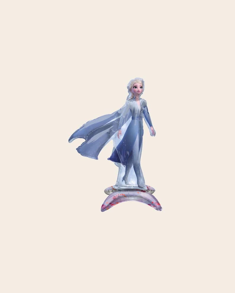 May include: An inflatable foil balloon shaped like a character with long blonde hair, wearing a light blue dress with a flowing cape. The figure stands on a crescent-shaped base that is light purple with small pink and red speckles throughout.