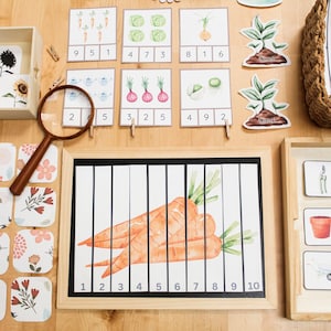 May include: A wooden educational set featuring watercolor illustrations of vegetables, flowers, and gardening tools. Includes a magnifying glass, number cards, and a puzzle of carrots. The set is designed for learning and play.