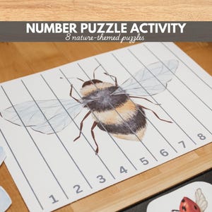 May include: A number puzzle activity featuring a watercolour illustration of a bee. The puzzle is divided into eight sections, each numbered. The text at the top reads "NUMBER PUZZLE ACTIVITY" and "8 nature-themed puzzles".