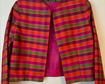 May include: A red, green, and pink plaid silk jacket with a pink lining. The jacket is size 8 and is made in the USA. The label reads "Vinci Clothiers". The jacket measures 18 inches across the shoulders and 19 inches in length.