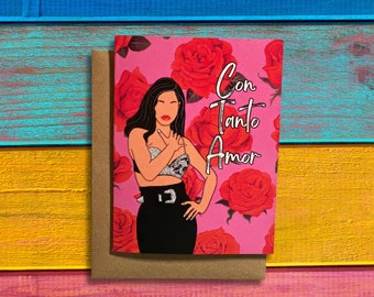 May include: A pink greeting card with a drawing of a woman with long black hair wearing a black outfit and a sparkly top. The background is pink with red roses and the text "Con Tanto Amor" in silver lettering.