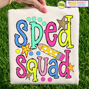 May include: Cream-colored sweatshirt with the words "SPED SQUAD" in colorful bubble letters. The design includes a yellow pencil, stars, and polka dots. The sweatshirt is held up by a hand.