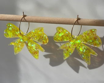 Handmade glitter bow earrings. On gold-plated or silver tone stainless steel loops. Can be made in any colour. Bows ribbon hoops