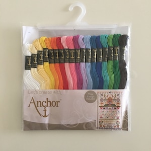 May include: A package of 16 skeins of Anchor embroidery floss in a rainbow of colors. The floss is packaged in a clear plastic bag with a white hanger. The package includes a free design for a cross-stitch pattern.