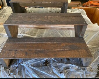 May include: Two wooden steps with a dark brown stain. The steps are made of reclaimed wood and have a rustic look.