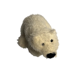 May include: A plush polar bear toy in a crouching position. The bear has soft, white fur, black eyes, and a black nose. The toy is designed to resemble a polar bear cub.