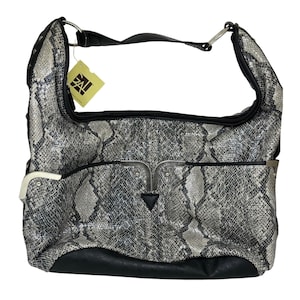 May include: A hobo-style shoulder bag featuring a grey and black snakeskin pattern. The bag includes a solid black base, silver-tone metal hardware accents, and a black strap attached with silver rings. A yellow tag with the text GAL is attached.