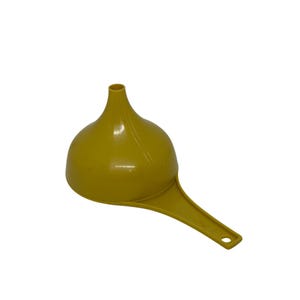 May include: A mustard-yellow plastic funnel with a wide, rounded bowl and a long, flat handle. The handle has a small hole at the end for hanging. The funnel is designed for pouring liquids or powders into containers.
