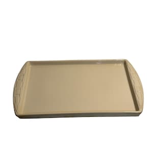 May include: A rectangular, off-white ceramic serving tray. The tray has a slightly speckled surface and rounded ends with a woven basket-like design. The tray is suitable for serving food or displaying decorative items.