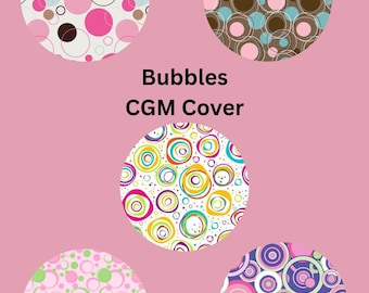 May include: A pink background features five circular designs with bubble patterns in various colors. The designs include pink, white, brown, blue, green, yellow, and purple circles. The text "Bubbles CGM Cover" is centered on the image.